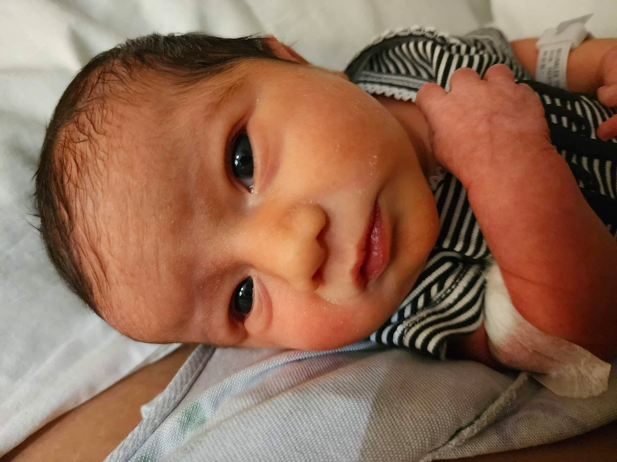 Montana joined the competition — help win amazing prizes! baby, baby_toddler_clothing, cheek, close_up, ear, eyebrow, eyelash, finger, gesture, hand, happy, human_body, iris, lip, mouth, neck, nose, organ, person, skin