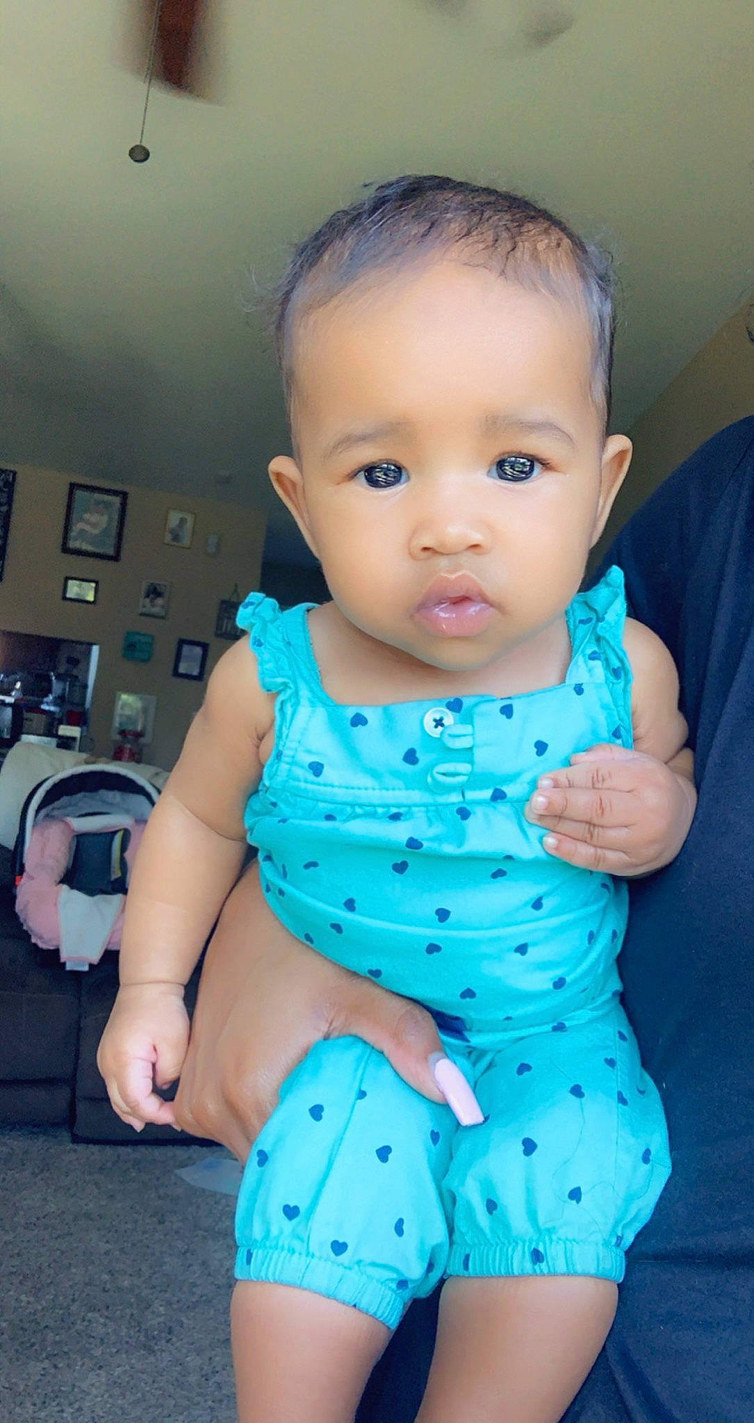 Leilani is registered to the contest to win money with this photo: arm, azure, baby, baby_toddler_clothing, blue, cheek, facial_expression, finger, hairstyle, hand, happy, human, iris, joint, luggage_and_bags, mouth, person, skin, sleeve, standing