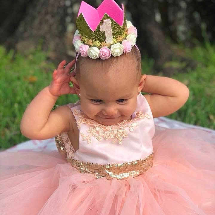 Skylynn Dream is registered to the contest to win money with this photo: baby, birthday, celebration, child, crown, cute, festive, flower_crown, girl, grass, happy, nature, one_year_old, outdoor, pink_dress, portrait, smiling, sparkle, tutu, young_child