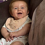 Arabella joined the competition — help win amazing prizes! baby, smiling, infant, face, bib, couch, clothing, happy, child, skin, hand, sitting, indoors, cute, young, closeup, person, apparel, comfort, portrait