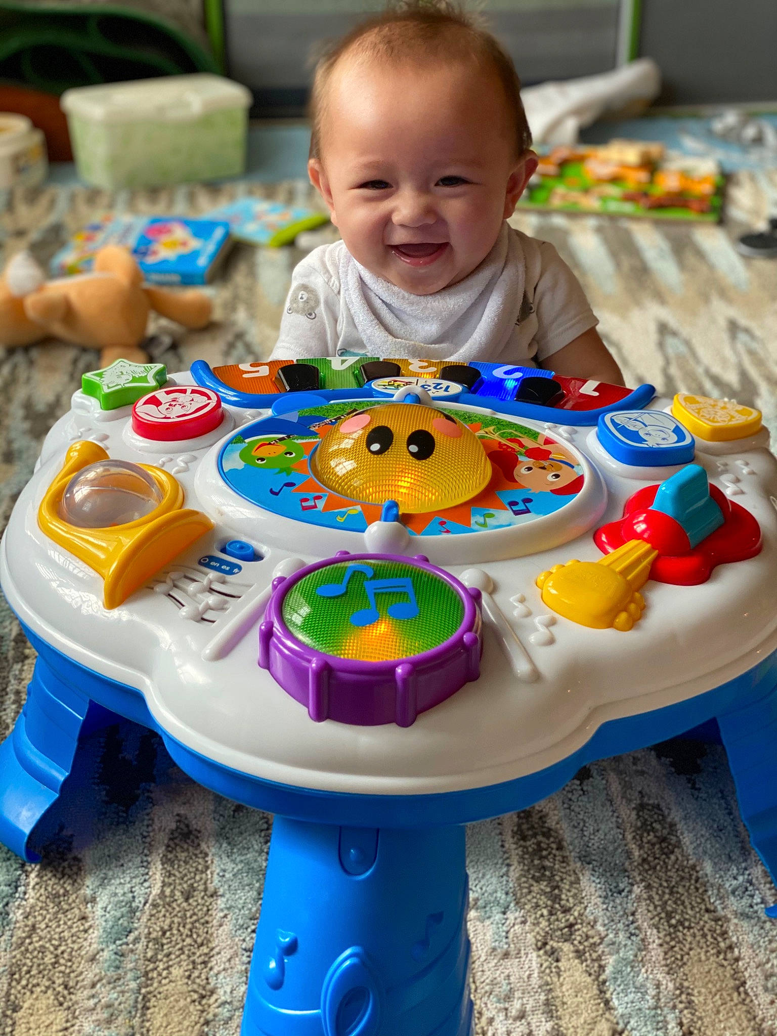Colt is registered to the contest to win money with this photo: baby, baby_products, baby_toddler_clothing, baby_toys, blue, chair, child, event, fun, green, happy, joy, leisure, person, play, product, recreation, sharing, smile, table
