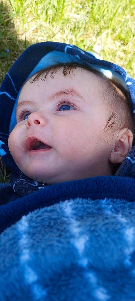 Finan is registered to the contest to win money with this photo: azure, baby, blue, cheek, chin, cool, eye, eyebrow, eyelash, grass, happy, headgear, iris, lip, nose, person, plant, skin, smile, toddler