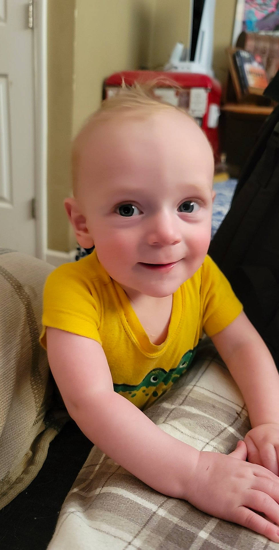 Harrison is registered to the contest to win money with this photo: baby, baby_toddler_clothing, chair, cheek, child, chin, comfort, door, eye, flooring, fun, happy, head, iris, joy, person, sitting, skin, sleeve, smile