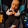 James joined the competition — help win amazing prizes! baby, infant, child, car_seat, pinstripe_suit, clothing, blue_eyes, hands, face, portrait, indoor, socks, cute, person, seat, looking, expression, young_child, fashion, baby_clothes