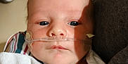 James is registered to the contest to win money with this photo: baby, newborn, hospital, oxygen_tube, blanket, infant, face, medical, patient, child, person, healthcare, closeup, wrapped, bed, resting, skin, indoors, treatment, care
