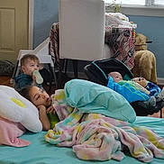 Jesslynn is registered to the contest to win money with this photo: baby, bed, blanket, bottle, car_seat, chair, child, cozy, floor, furniture, high_chair, indoor, person, pillow, plant, table, toddler, toy, window