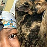 Candace-Elizabeth is registered to the contest to win money with this photo: person, cat, tortoiseshell_cat, face, headscarf, bed, blanket, indoor, closeup, cozy, pet, animal, resting, snuggle, fur, eyebrow, skin, expression, portrait, cute