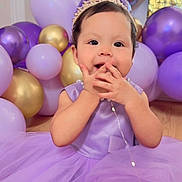 Aysha is registered to the contest to win money with this photo: baby, child, princess, tiara, purple_dress, balloons, party, celebration, smile, hands, cute, indoor, floor, tulle, dress, face, portrait, young, happy, light
