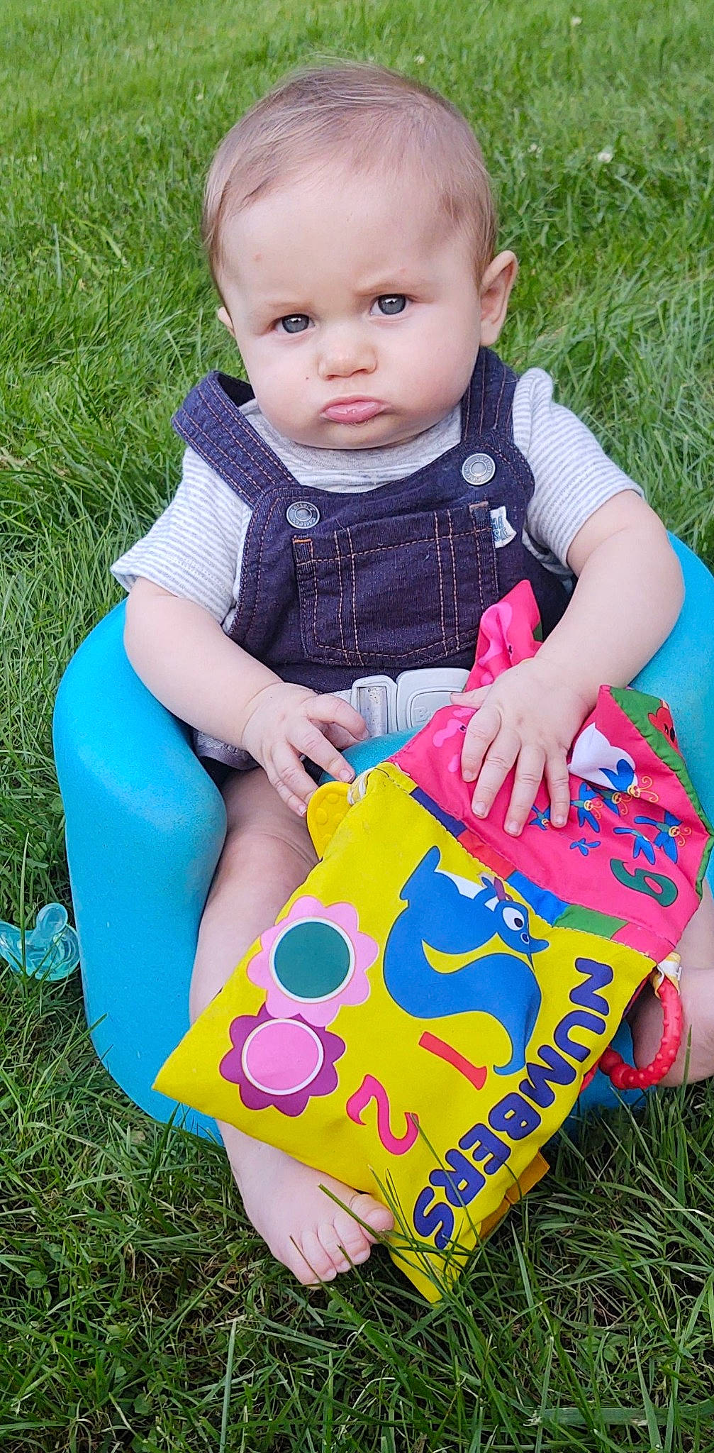 Jesse is registered to the contest to win money with this photo: baby, baby_products, baby_toddler_clothing, chair, child, dress, electric_blue, fun, grass, green, happy, lawn, pattern, people_in_nature, person, pink, sitting, t_shirt, toddler, white