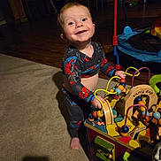 Alexander joined the competition — help win amazing prizes! baby, bead_maze, carpet, child, colorful, cute, furniture, happy, indoor, living_room, pajamas, person, play, shadow, smiling, spiderman, toddler, toy, wooden_floor, wooden_toy