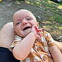 Wilbur is registered to the contest to win money with this photo: baby, child, infant, smiling, outdoor, grass, person, clothing, plaid, button, hand, lap, skin, happy, nature, sunlight, casual, cute, head, expression