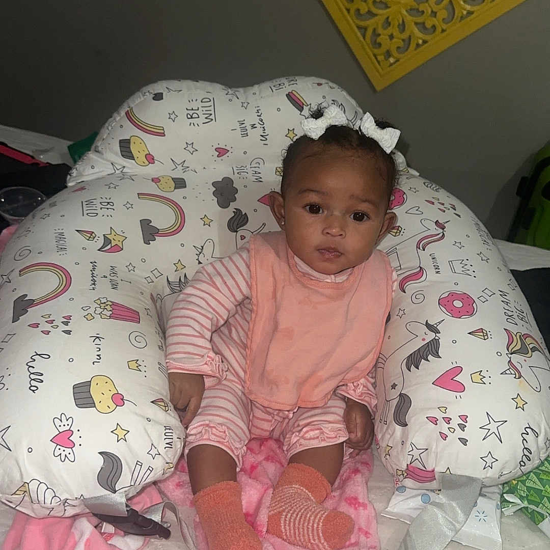 Chloe Jimison is registered to the contest to win money with this photo: baby, bed, bedroom, blanket, bonnet, clothing, couch, crib, cushion, face, furniture, hat, head, homedecor, indoors, infantbed, person, photography, portrait, room