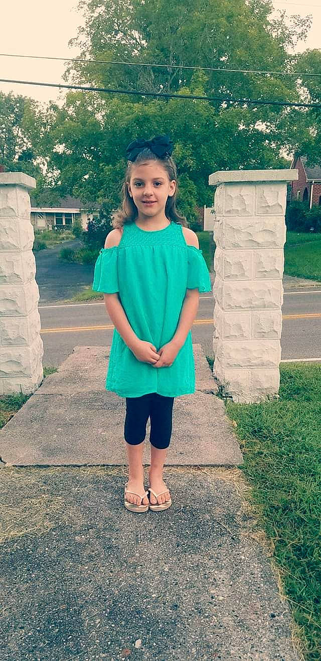 Haley joined the competition — help win amazing prizes! child, clothing, dress, footwear, grass, green, joy, pattern, person, photography, pink, shoe, shoulder, sleeve, smile, snapshot, standing, summer, t_shirt, turquoise