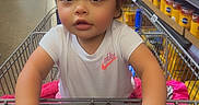 Amari joined the competition — help win amazing prizes! aisle, baby, canned_goods, child, clothing, curious, cute, footwear, grip, grocery_store, indoor, nike_logo, person, pink_bows, retail, shopping, shopping_cart, supermarket, toddler, white_shirt