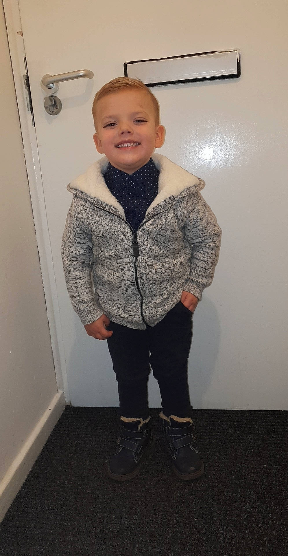 Kurtis is registered to the contest to win money with this photo: child, clothing, jacket, joy, outerwear, person, shoe, standing, toddler, top, white