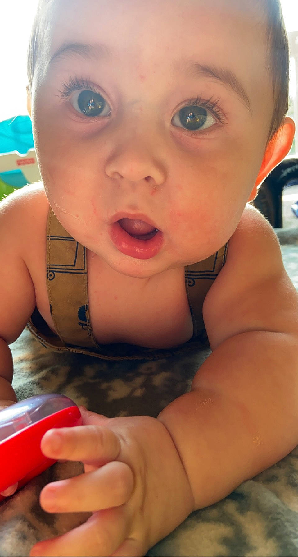 Leonidas is registered to the contest to win money with this photo: baby, baby_toddler_clothing, cheek, chest, child, communication_device, eyelash, finger, fun, happy, iris, lip, mobile_phone, nail, nose, person, portable_communications_device, sitting, skin, surprise