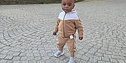 Ibrahim participe au concours pour gagner de l'argent avec cette photo : child, toddler, standing, tracksuit, sneakers, cobblestone, pavement, outdoors, trees, park, portrait, face, head, expression, sidewalk, cute, urban, person, clothing, walking