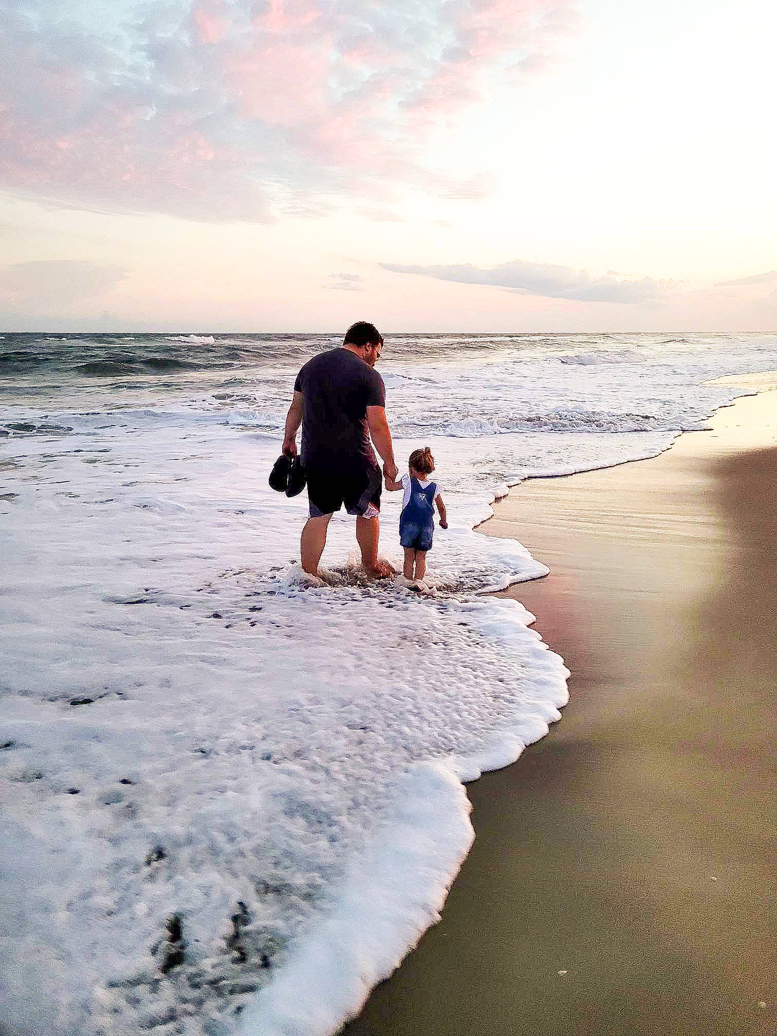 Isabella is registered to the contest to win money with this photo: beach, calm, cloud, coastal_and_oceanic_landforms, dusk, flash_photography, fun, gesture, happy, horizon, landscape, leisure, people_in_nature, people_on_beach, person, sand, sky, sunlight, travel, water