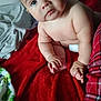 baby, child, infant, blanket, red_blanket, diaper, skin, hand, foot, face, eyes, indoors, soft_texture, plush, cute, chubby, sitting, curious, person, home