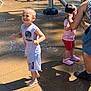 Nathaniel Truncer is registered to the contest to win money with this photo: child, boy, girl, water, splash_pad, playground, outdoor, summer, fun, happy, barefoot, clothing, shoes, water_spray, adult, tattoo, shadow, sunlight, concrete, family
