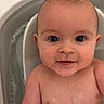 baby, bare_torso, bath_time, bathtub, bubbles, chubby_cheeks, close_up, cute, head, infant, looking_at_camera, plastic_tub, portrait, sitting, skin, smile, water, wet_skin, wide_eyes, young_child