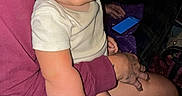 Dustin joined the competition — help win amazing prizes! adult, blanket, blue_eyes, casual_clothing, child, cozy, face, flash, hair, hand, indoor, lap, maroon, person, phone, purple, seated, skin, smile, toddler