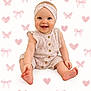 baby, smiling, sitting, headband, onesie, cute, happy, infant, pink, pattern, background, heart, butterfly, bow, child, portrait, skin, feet, hand, clothing