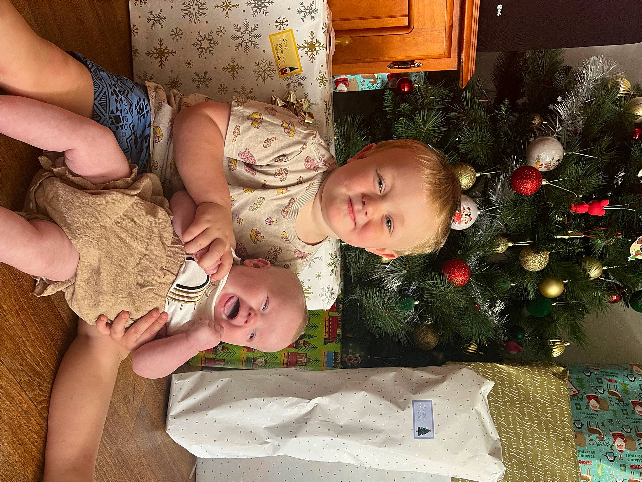 Penelope joined the competition — help win amazing prizes! baby, baby_toddler_clothing, child, christmas, christmas_decoration, christmas_ornament, christmas_tree, event, eye, gesture, hair, happy, head, holiday, holiday_ornament, human_body, joy, lap, person, plant