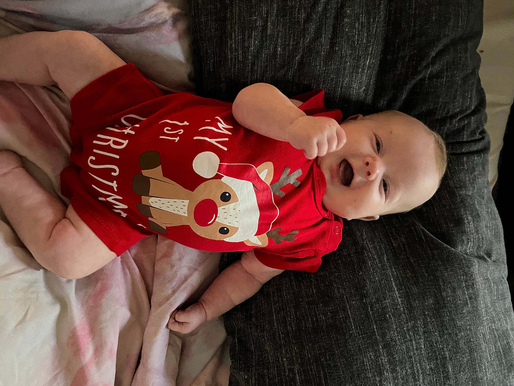 Penelope is registered to the contest to win money with this photo: baby, baby_toddler_clothing, carmine, child, elbow, eye, hand, happy, hat, human_body, pattern, person, sitting, sleeve, sock, t_shirt, thigh, toddler, wood, wrist