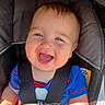 baby, child, car_seat, smile, happy, blue_clothing, seatbelt, infant, cute, portrait, sunlight, safety_harness, young_child, seat, person, cheerful, closeup, joy, baby_face, casual