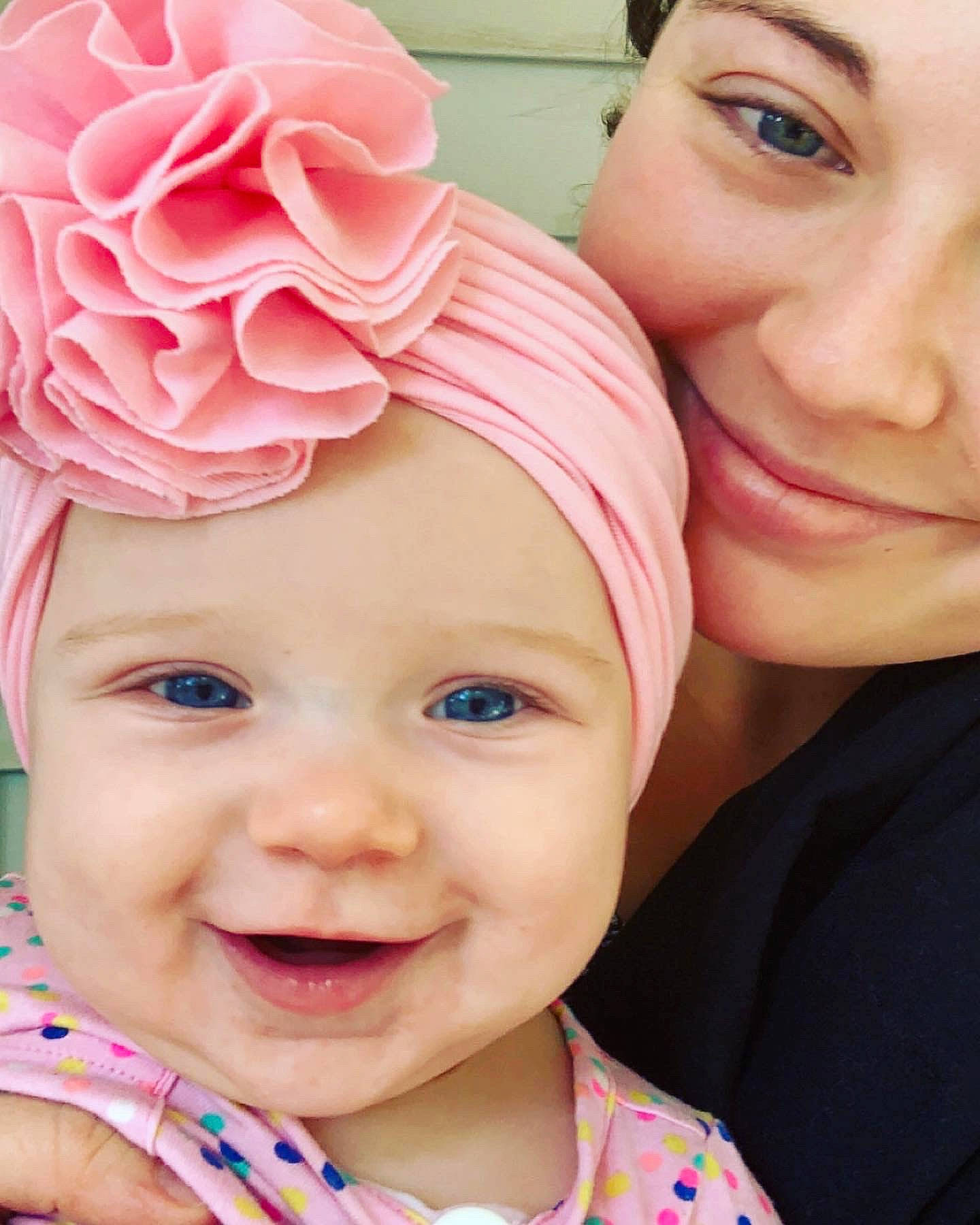 Iris is registered to the contest to win money with this photo: cheek, chin, eye, eyebrow, eyelash, face, happy, head, headgear, headwear, iris, joy, lip, nose, organ, person, petal, pink, plant, product