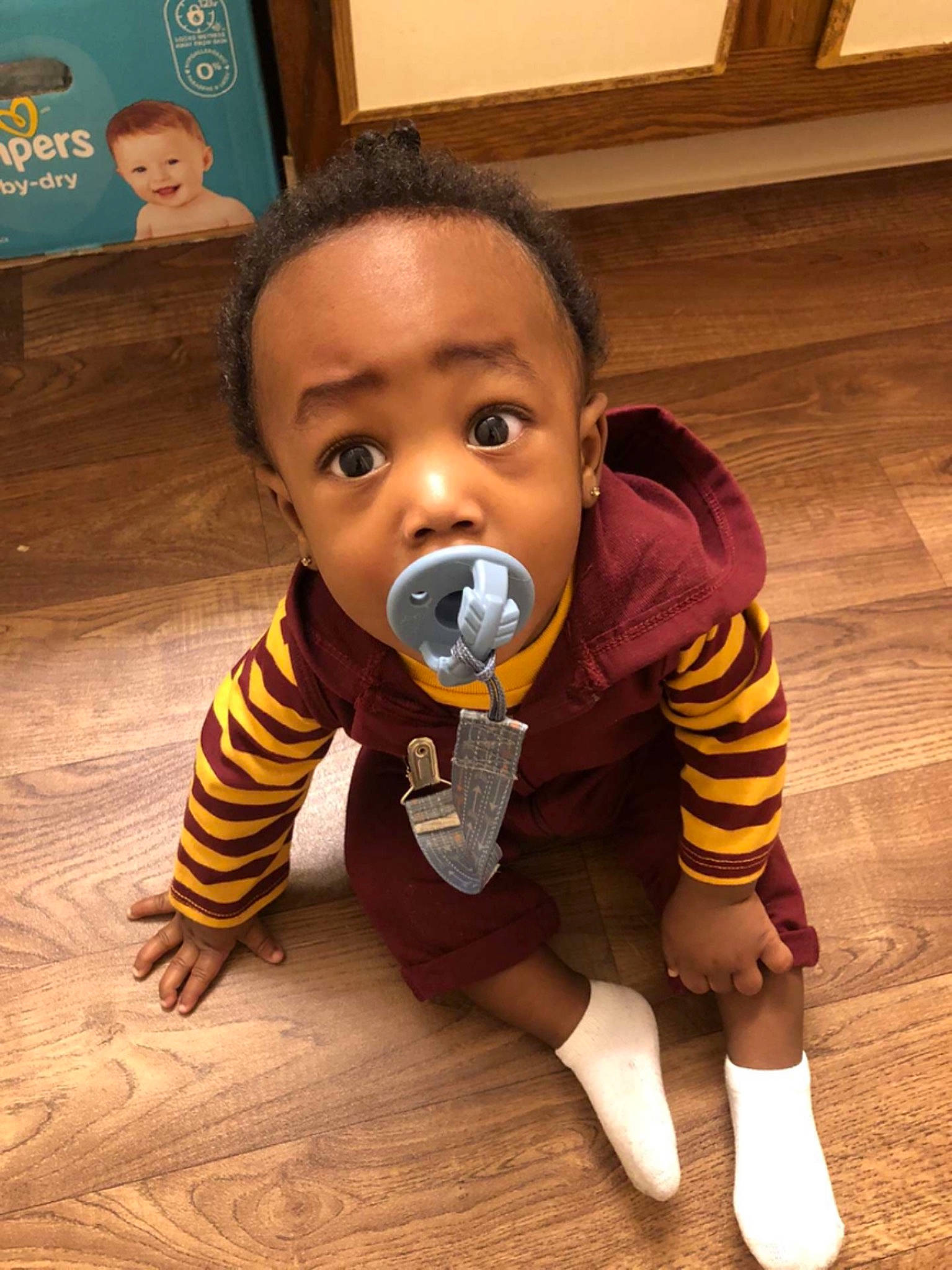 Naszeair is registered to the contest to win money with this photo: baby, baby_toddler_clothing, cheek, child, crawling, eye, face, floor, flooring, fun, happy, hardwood, head, joy, nose, person, play, sitting, skin, smile