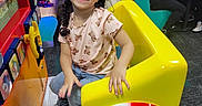 Jowhara joined the competition — help win amazing prizes! child, girl, smile, braided_hair, amusement_ride, arcade, indoor, family, people, table, colorful, clothing, shoe, play, fun, entertainment, happy, seated, restaurant, toy