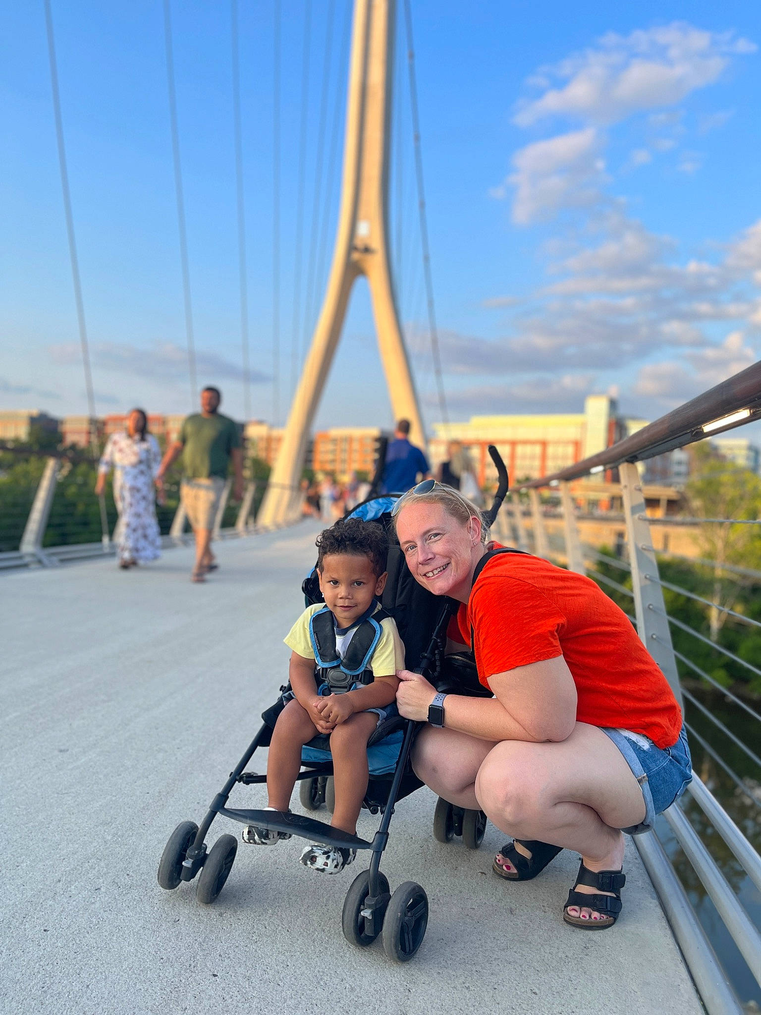 Emerson joined the competition — help win amazing prizes! baby, bridge, city, cloud, fence, fun, happy, joy, leisure, nonbuilding_structure, person, pole, recreation, rolling, shorts, sitting, sky, smile, tire, toddler