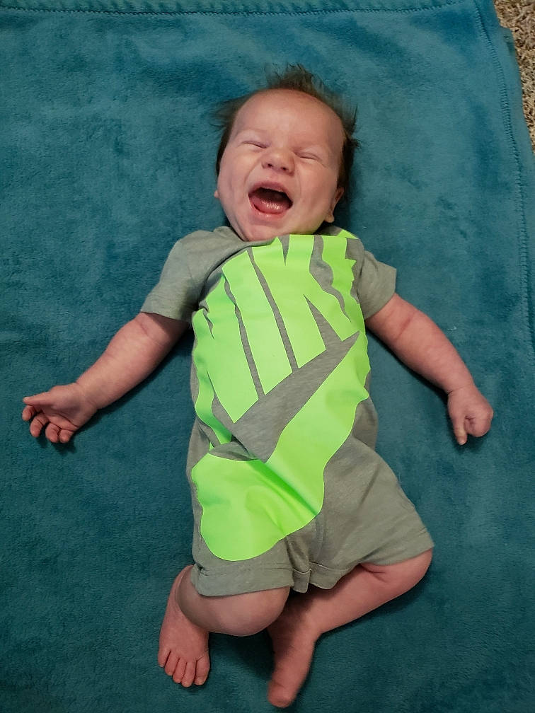 Benjamin is registered to the contest to win money with this photo: arm, baby, baby_products, baby_toddler_clothing, child, facial_expression, fun, green, head, person, product, skin, sleeve, smile, t_shirt, toddler