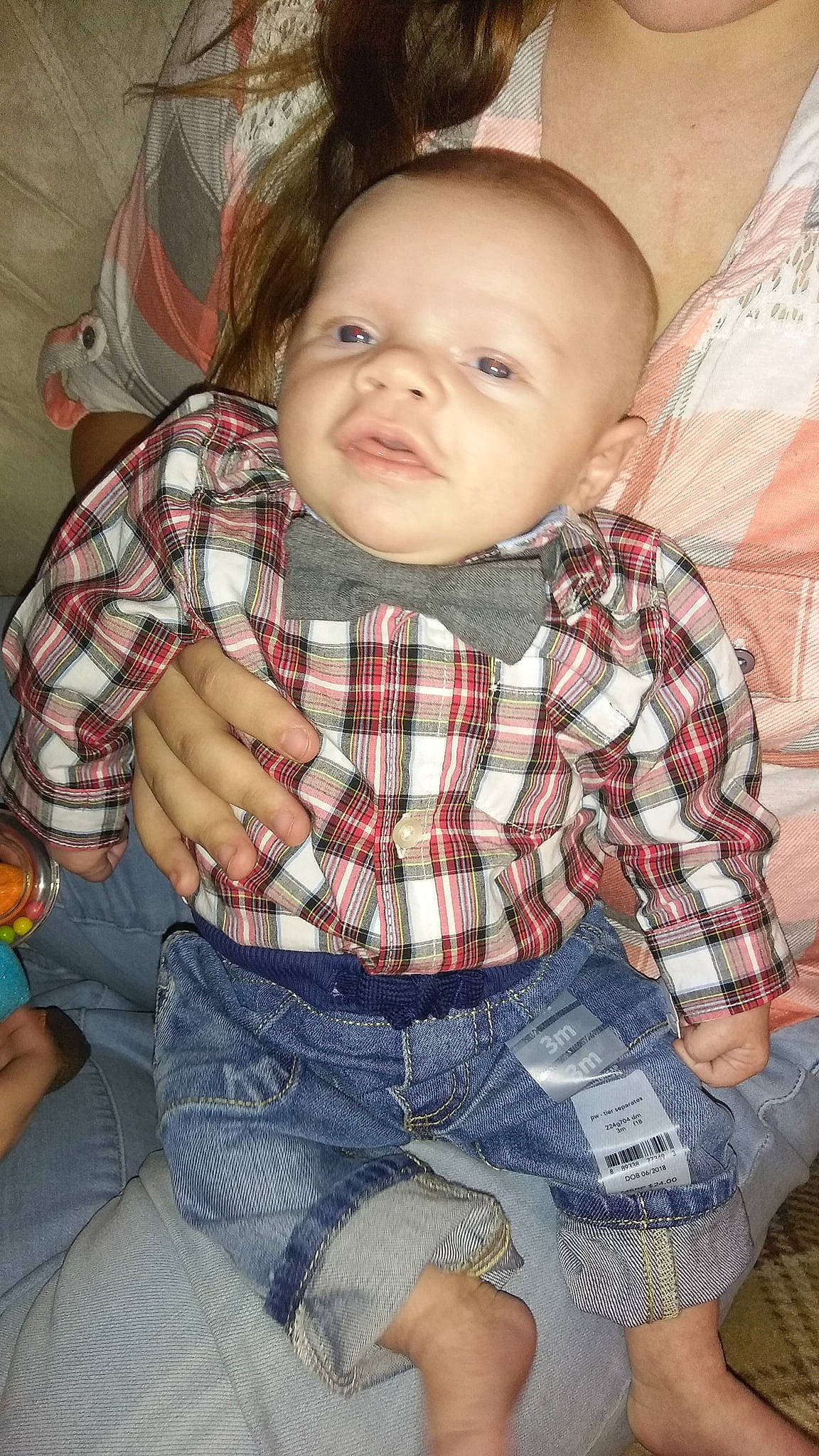 Jaxson is registered to the contest to win money with this photo: arm, boy, cheek, child, eye, face, finger, girl, head, infant, mouth, nose, pattern, person, plaid, product, sitting, skin, smile, tartan