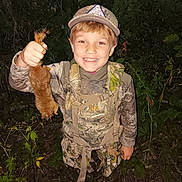 Jeremiah joined the competition — help win amazing prizes! child, boy, smiling, camouflage_clothing, hat, animal, forest, night, hunting, nature, outdoor, greenery, plants, wildlife, person, holding, young, adventure, proud, youth