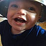 toddler, child, smiling, face, helmet, metal_bowl, indoor, happy, teeth, blue_shirt, closeup, headwear, funny, playful, cute, person, young_child, expression, looking_up, floor