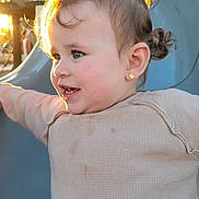 Jade is registered to the contest to win money with this photo: accessories, baby, bodypart, clothing, face, finger, hair, happy, head, knitwear, outdoorplayarea, outdoors, person, photography, playarea, portrait, slide, smile, sweater, toy