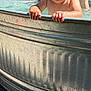 Lillian joined the competition — help win amazing prizes! child, toddler, water, metal_tub, outdoor, summer, sunlight, splashing, happy, smiling, person, pool, bare_chest, playing, adult, shorts, nature, leaf, fun, family