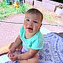 Lillian is registered to the contest to win money with this photo: toddler, child, outdoor, grass, toy, planter, rug, sitting, smiling, short_hair, shirt, barefoot, sunlight, garden, play, person, happy, summer, casual, daylight