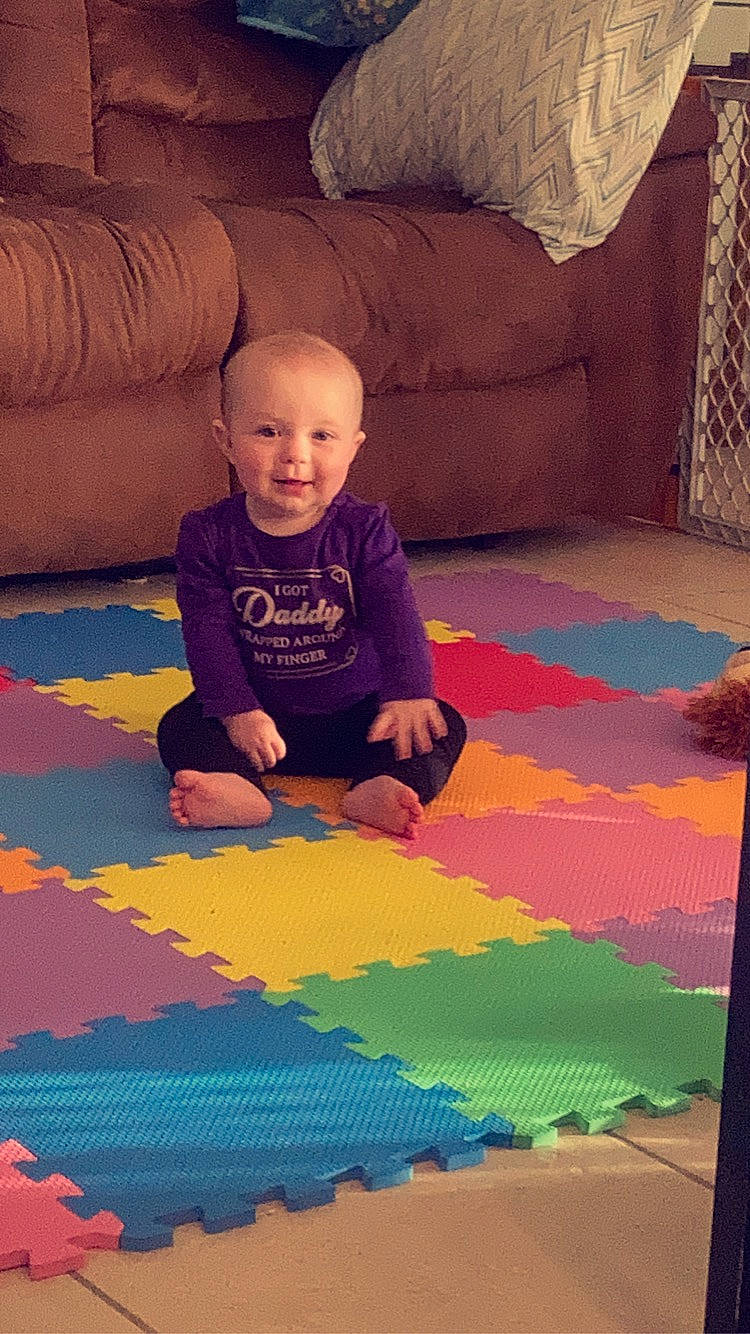 Adalynn is registered to the contest to win money with this photo: art, baby, carpet, child, comfort, floor, flooring, fun, hardwood, leisure, linens, orange, person, play, product, room, sitting, textile, tints_and_shades, toddler