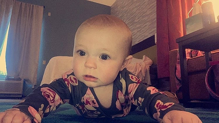 Adalynn is registered to the contest to win money with this photo: baby, baby_toddler_clothing, cheek, child, comfort, crawling, curtain, flash_photography, floor, flooring, fun, human_body, human_leg, iris, mouth, nose, person, sitting, skin, toddler