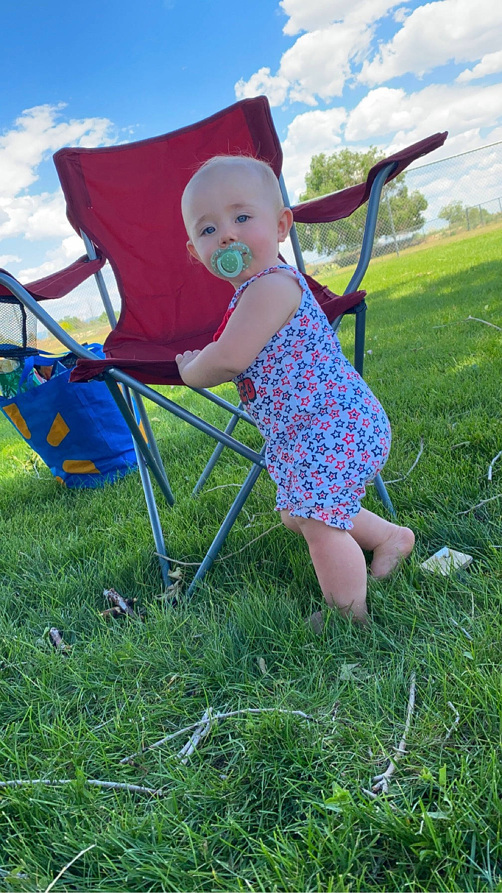 Raylynn is registered to the contest to win money with this photo: baby_toddler_clothing, blue, chair, child, cloud, comfort, electric_blue, event, grass, grass_family, grassland, happy, leisure, outdoor_furniture, people_in_nature, person, plant, recreation, sitting, sky
