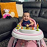 Leonna joined the competition — help win amazing prizes! baby, walker, smile, indoor, couch, pillow, toy, doll, child, happy, living_room, carpet, footwear, person, hair_bow, milestone, furniture, pink, gray, playtime