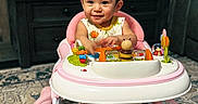 Leonna joined the competition — help win amazing prizes! baby, child, walker, toys, headband, smile, indoor, carpet, furniture, living_room, pink, colorful, cute, happy, person, floor, seat, play, young, infant