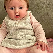 élya participe au concours pour gagner de l'argent avec cette photo : baby, child, infant, cute, pink, clothing, sitting, face, hand, expression, soft_texture, home_interior, portrait, cozy, apparel, human, young, warm, curious, indoor