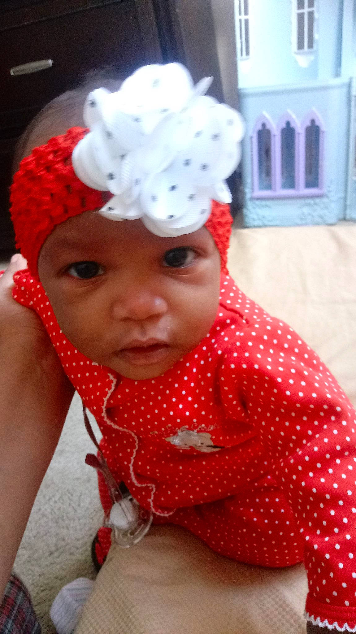 Rylie is registered to the contest to win money with this photo: beanie, cap, child, design, fashion_accessory, girl, hair_accessory, hat, headgear, headpiece, infant, knit_cap, pattern, person, polka_dot, product, red, toddler