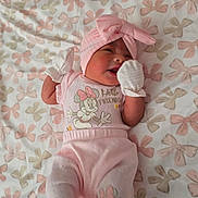 Camila joined the competition — help win amazing prizes! baby, pink, mittens, blanket, bow, infant, clothing, pattern, cute, lying_down, soft, toddler, headwear, sleepwear, smiling, face, person, indoors, fabric, comfort