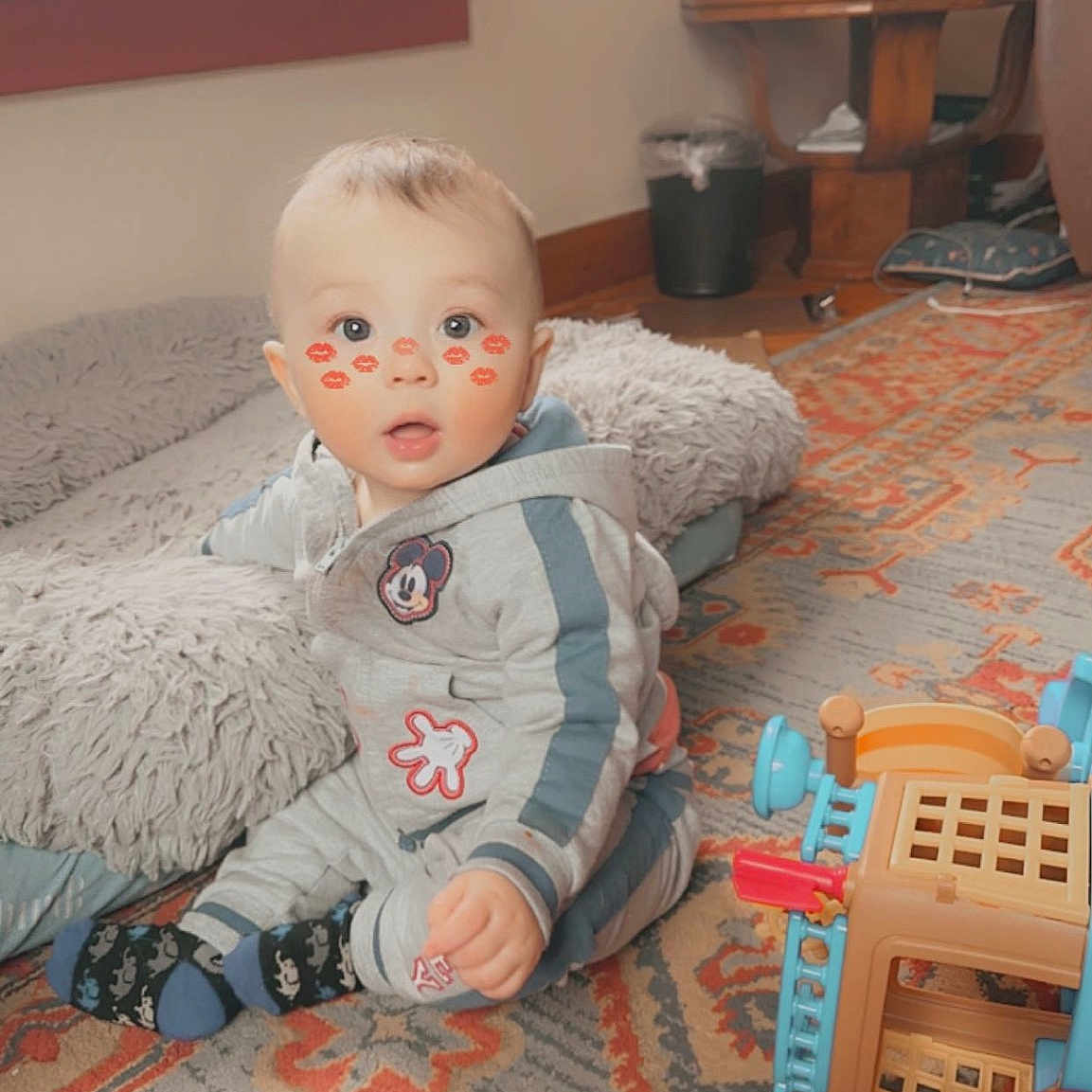 Hutson is registered to the contest to win money with this photo: art, baby, baby_toddler_clothing, baby_toys, carpet, cheek, child, curtain, doll, floor, flooring, fun, living_room, room, sitting, toddler, toy, window, window_blind, wood